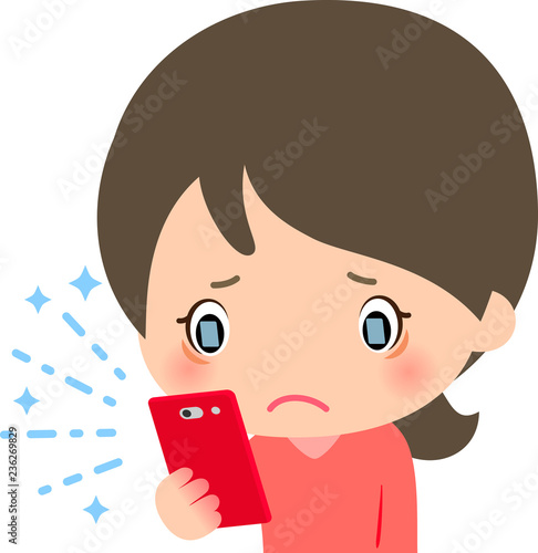 ブルーライトが出るスマートフォンを凝視する女性
