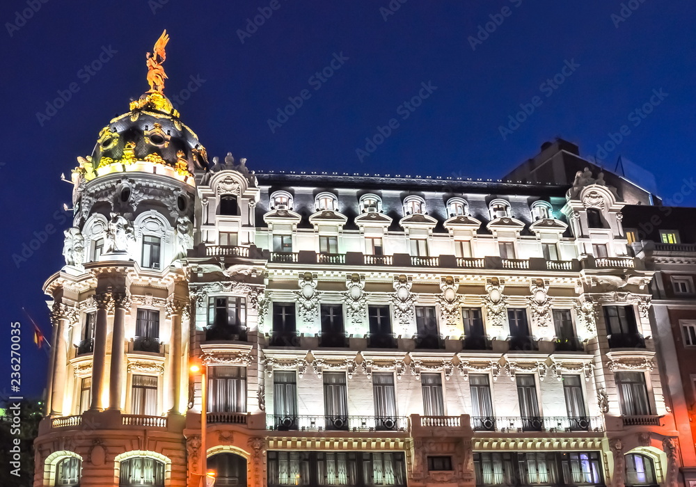 Architecture of Gran Via street at night, Madrid, Spain