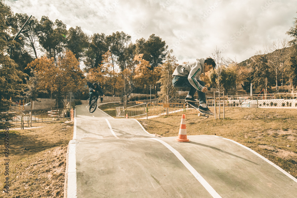 Guy skateboarding in a park. Skateboarder jumping on skateboard Guy skateboarding in a park. Skateboarder jumping on skateboard