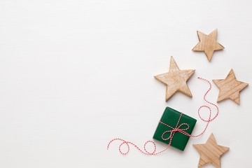 Christmas composition. Wooden decorations, stars on white background. Christmas, winter, new year concept. Flat lay, top view, copy space.