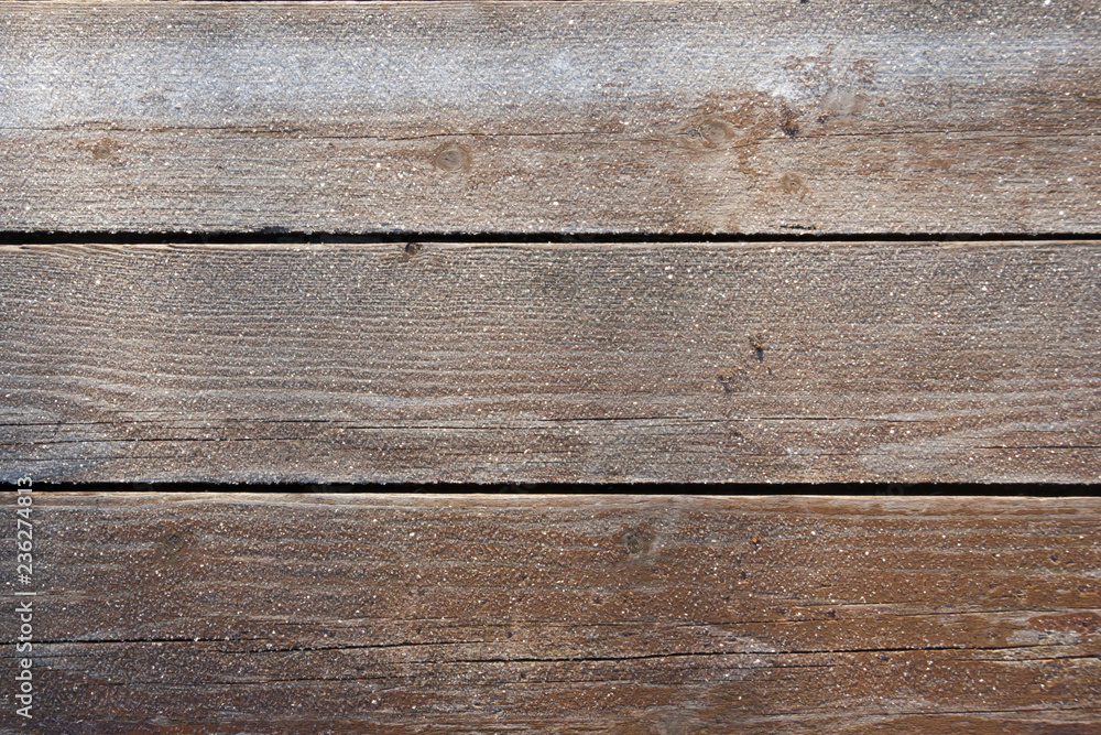 Frozen wood boards background. It is real foto in sunny frosty day