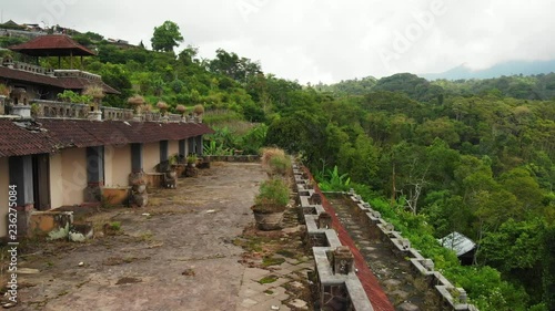 Aerial drone video of woman in abandoned hotel in Bedugul, Bali island.