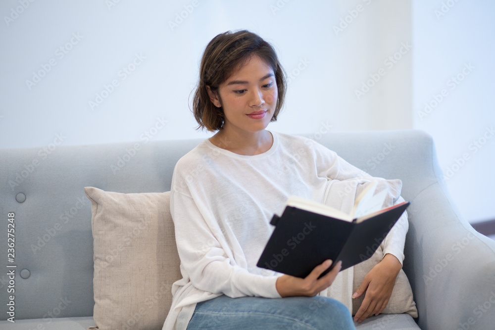 Positive Asian student preparing for class. Beautiful young girl reviewing her study notes at home. Self-tuition concept Positive Asian student preparing for class. Beautiful young girl reviewing her study notes at home. Self-tuition concept