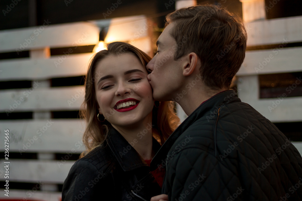 the guy kisses the smiling girl the guy kisses the smiling girl