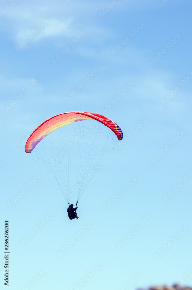 Paraglider against the sky. Russia, Republic of Crimea. 06.13.2018. Flight of a paraglider athlete against the sky Paraglider against the sky. Russia, Republic of Crimea. 06.13.2018. Flight of a paraglider athlete against the sky