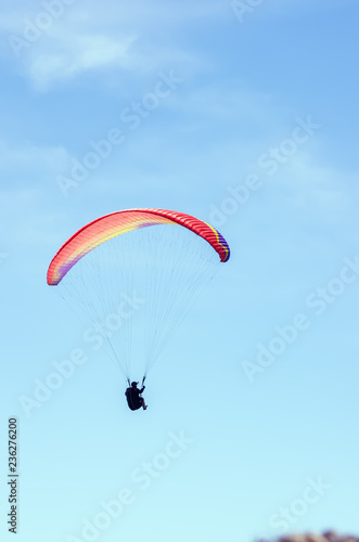 Paraglider against the sky. Russia, Republic of Crimea. 06.13.2018. Flight of a paraglider athlete against the sky