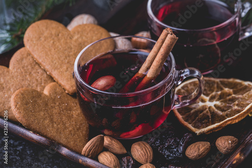 Mulled wine with heart shaped gingerbread cookies, almonds, raisins and dried sliced oranges.