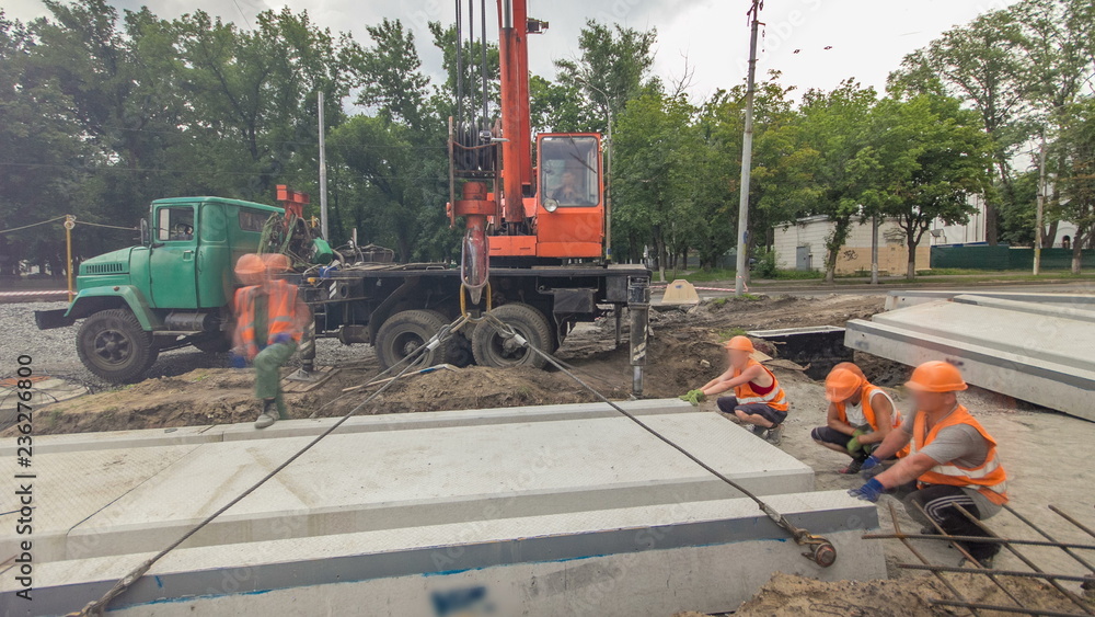 Installing concrete plates by crane at road construction site timelapse hyperlapse. Installing concrete plates by crane at road construction site timelapse hyperlapse.