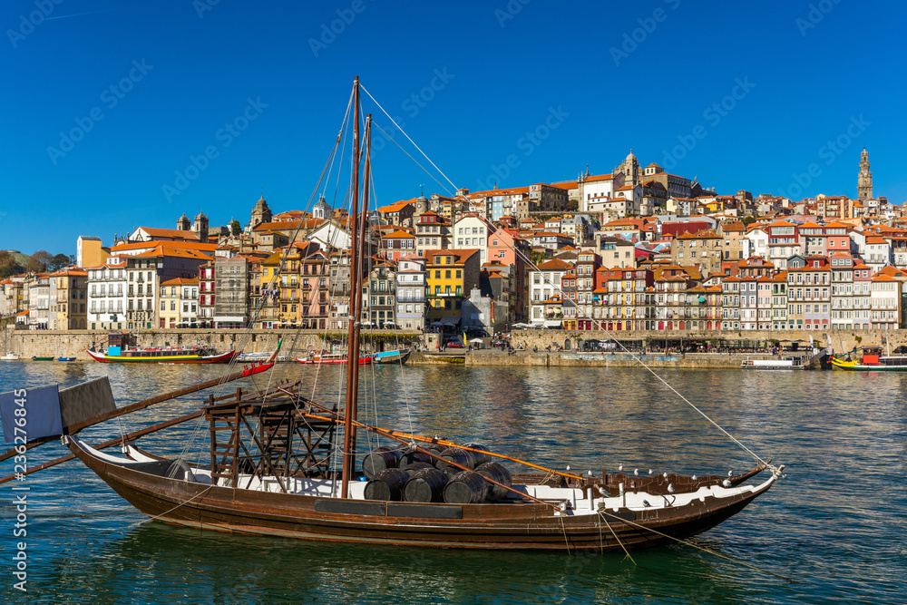 Oporto or Porto city skyline, Douro river, traditional boats and Dom Luis or Luiz iron bridge. Porto, Portugal, Europe.