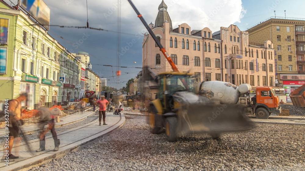 Fototapeta premium Concrete works for road construction with many workers and mixer timelapse