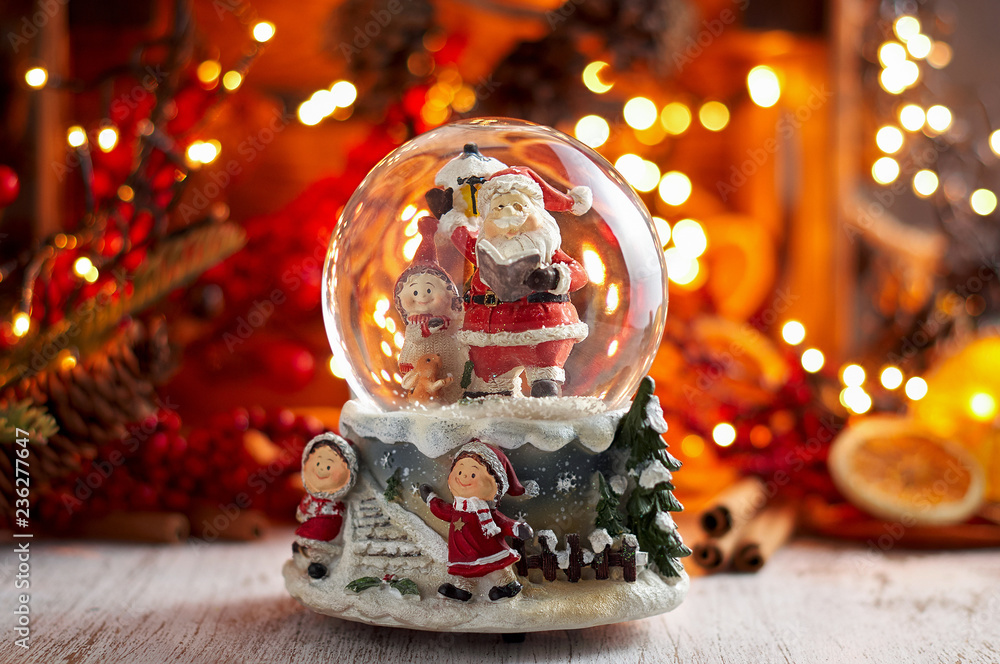 Musical Snow Globe with Santa Claus on bokeh background