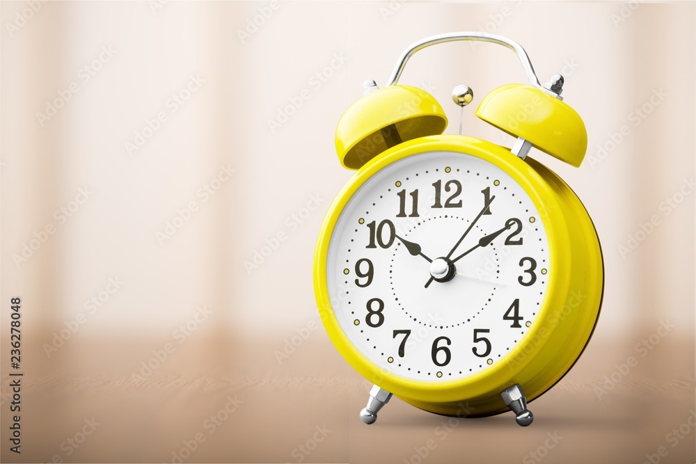 Retro alarm clock on blurred background Retro alarm clock on blurred background