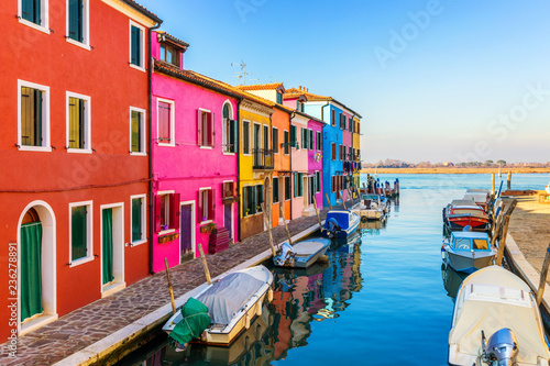 Beautiful view of the canals of Burano with boats and beautiful, colorful buildings. Burano village is famous for its colorful houses. Venice, Italy. © daliu
