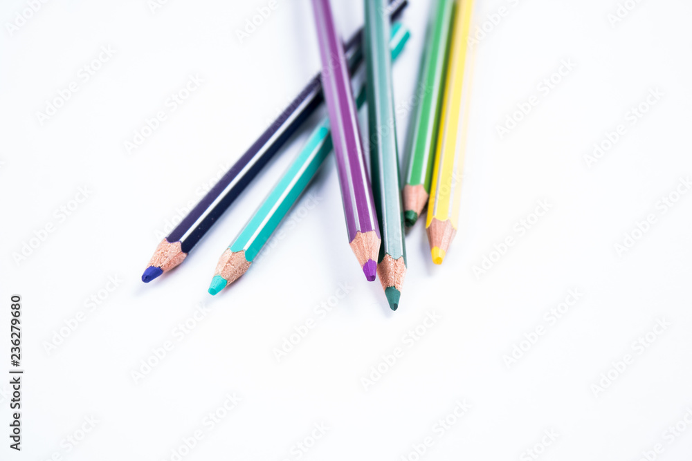 Fototapeta premium School equipment: colored pensils on white background.