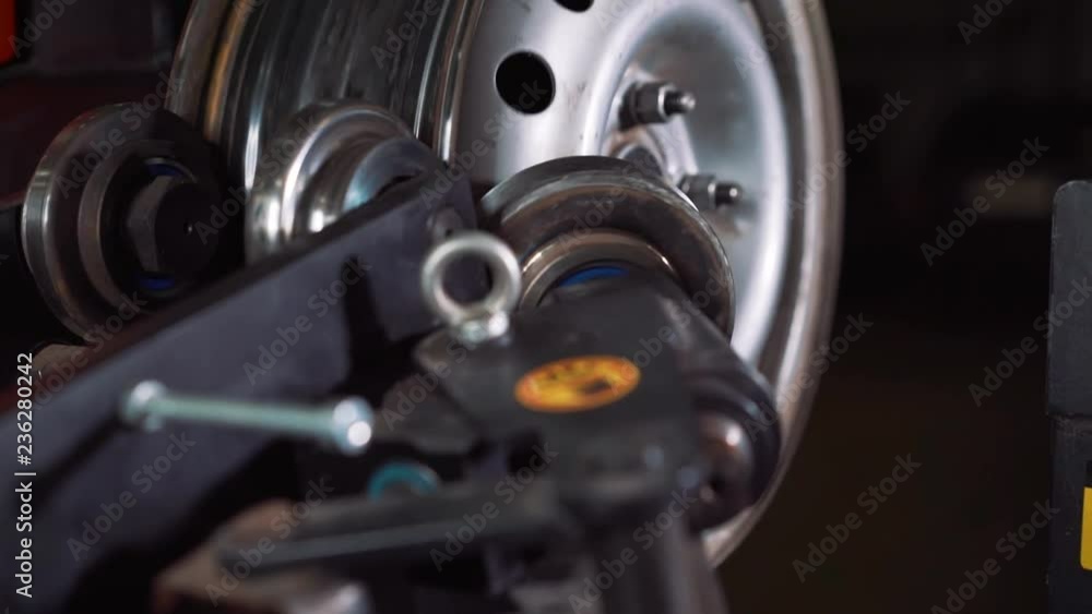 Equipment for car service and repair - tire machine for rolling and alignment of steel wheel rims close-up Equipment for car service and repair - tire machine for rolling and alignment of steel wheel rims close-up
