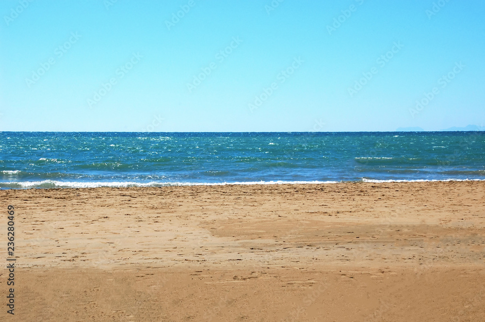 Uninhabited beach, sea view with wave, sand and sky