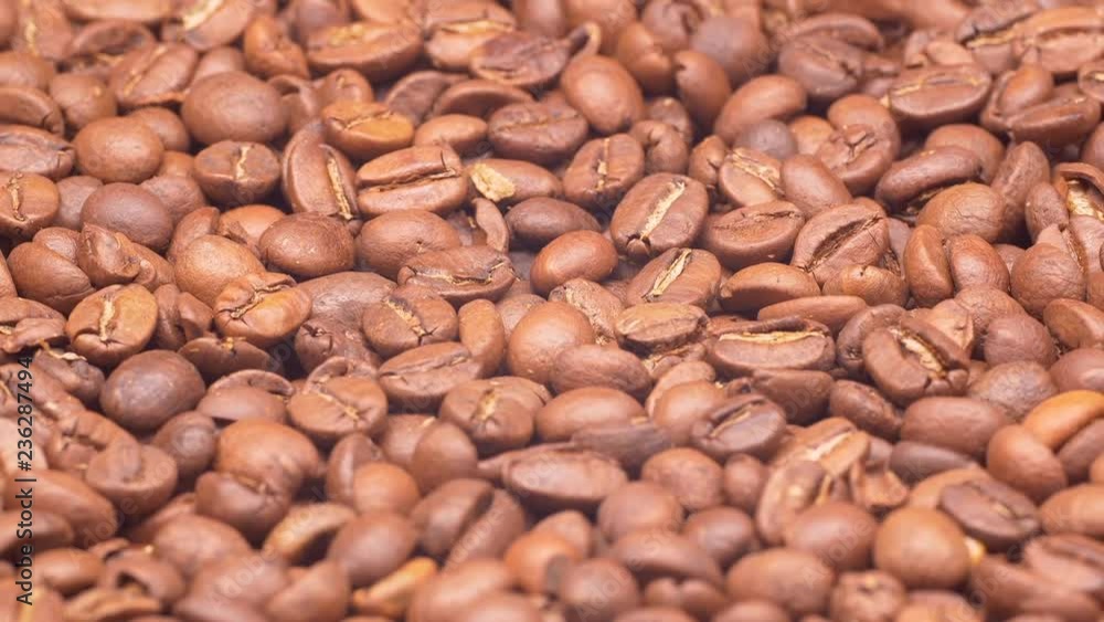 UHD closeup shot of the light or medium roasted coffee beans on a turntable UHD closeup shot of the light or medium roasted coffee beans on a turntable