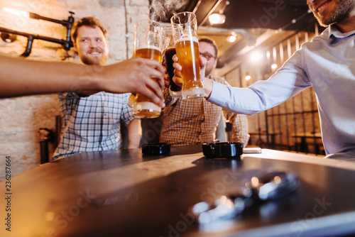 Men drinking beer and on desk car keys.