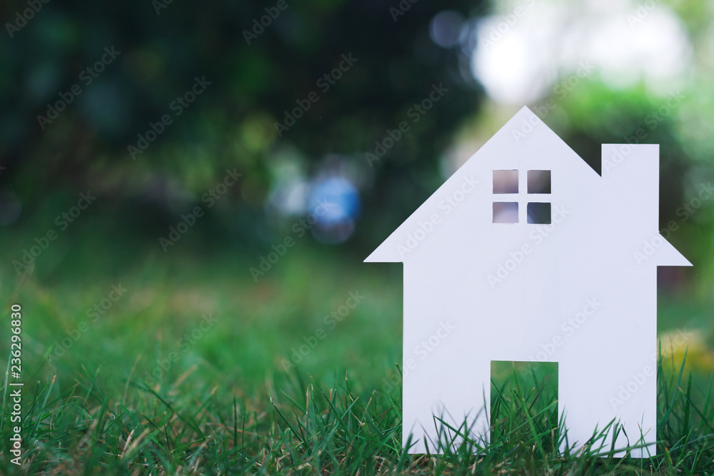 Paper House on field bokeh background with copy space