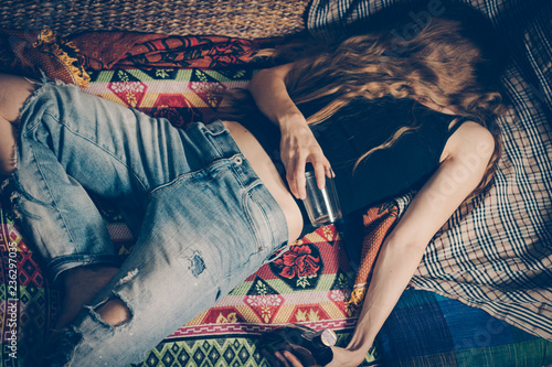 Young drunk woman on the sofa. Drug addicted, alcoholism, depression.