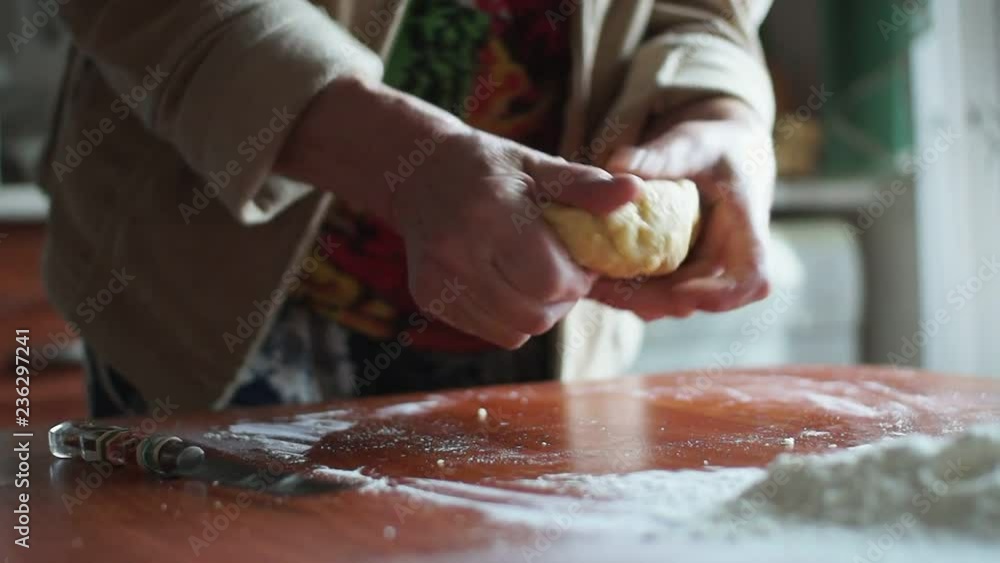 Woman kneading dough in flour on table Woman kneading dough in flour on table