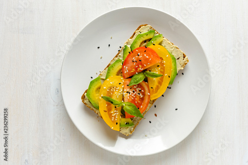 Foto Avocado and tomato toast on plate with copy space