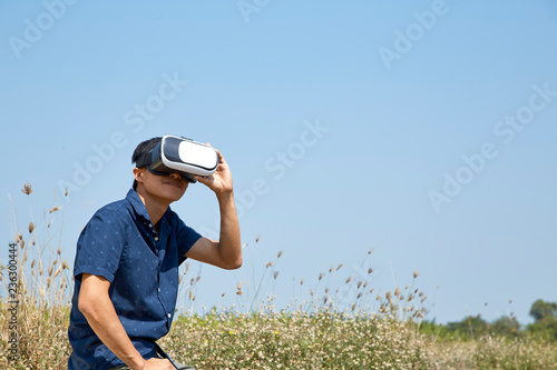 Asian man using the virtual reality headset