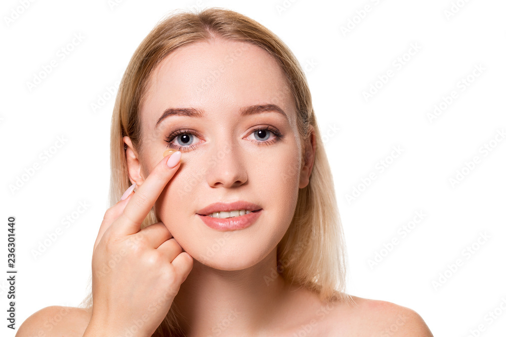 Young woman holding contact lens on index finger with copy space. Close up face of healthy beautiful woman about to wear contact lens. Young woman holding contact lens on index finger with copy space. Close up face of healthy beautiful woman about to wear contact lens.
