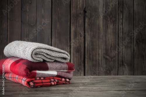 stack of plaids on wooden background photo