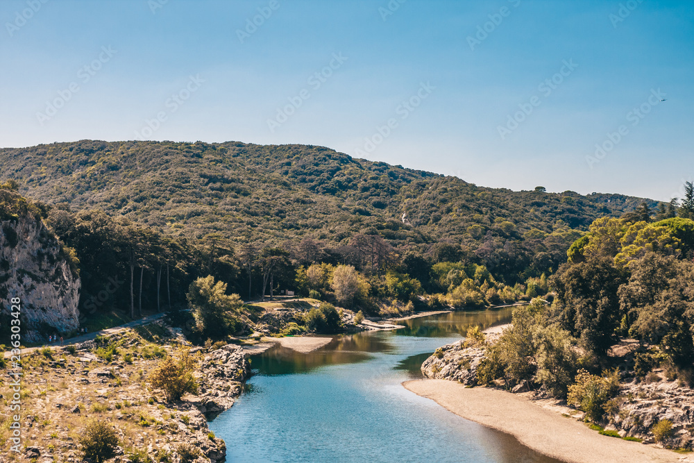 View of the Gardon riverbed not far from the Pont du Gard aqueduct View of the Gardon riverbed not far from the Pont du Gard aqueduct