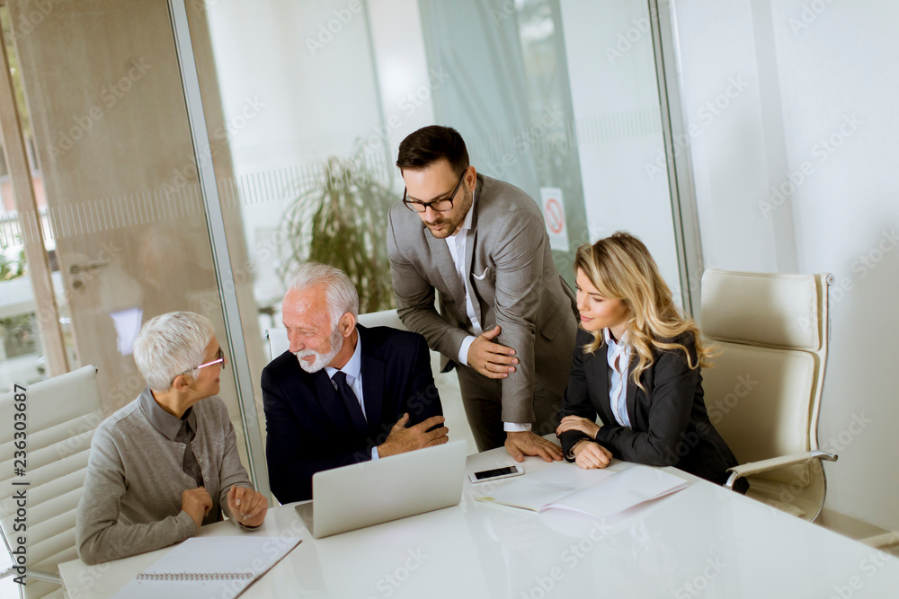 Businesspeople in conference room during a meeting in office Businesspeople in conference room during a meeting in office