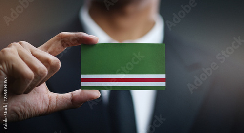 Businessman Holding Card of Chechen Republic of Ichkeria Flag