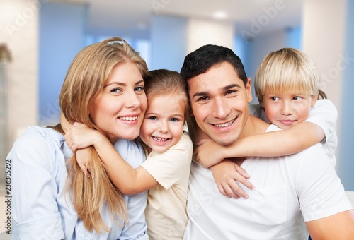 Beautiful smiling family in room on couch