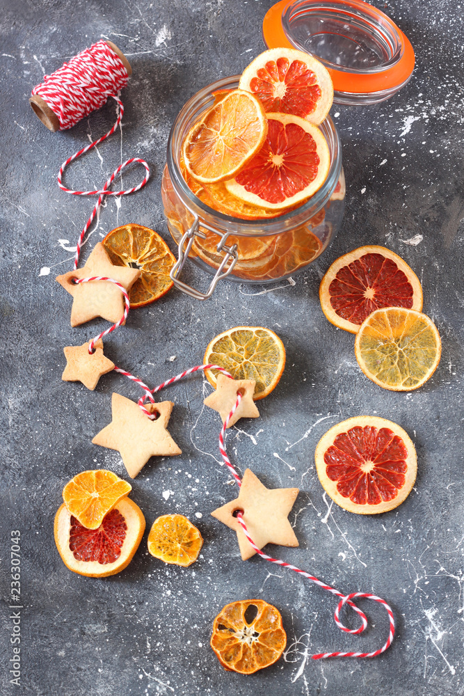Christmas background with gingerbread cookies and dried oranges slices.Top view