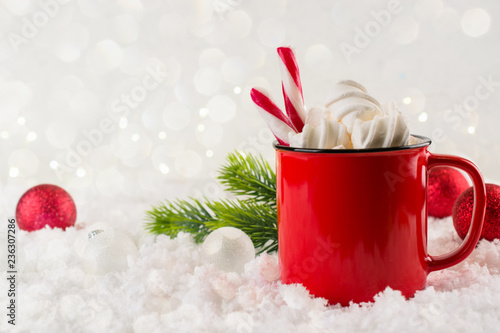 Winter hot drink, cacao with marshmallows or spicy hot chocolate in red cup. Festive vintage background. Copy space for text.