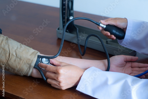 close up hand of doctor and patient using checking measuring arterial blood pressure . healthcare or Health check, hospital and medicine concept