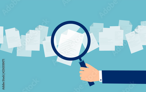 Employer with magnifying glass exploring application papers photo