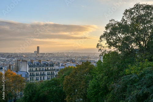 View from the Sacre Coeur Basilica of Montmartre district with the Montparnasse Tower in the background at sunset