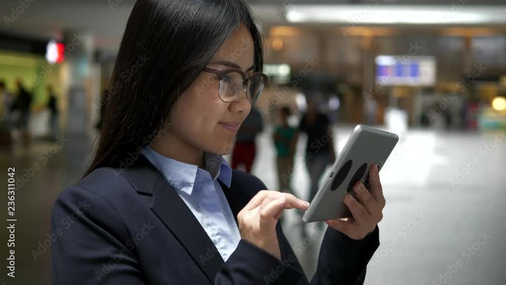 Female Commuter Traveling Searching the Web Online on Tablet Touch Screen Female Commuter Traveling Searching the Web Online on Tablet Touch Screen