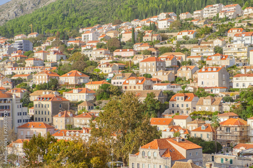 Scenic view of urban part on hills in ancient touristic town Dubrovnik in Croatia. Beautiful aerial view of old european resort on Adriatic sea.