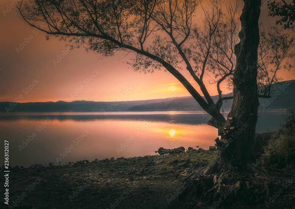 Naklejka premium sunset shore lake
