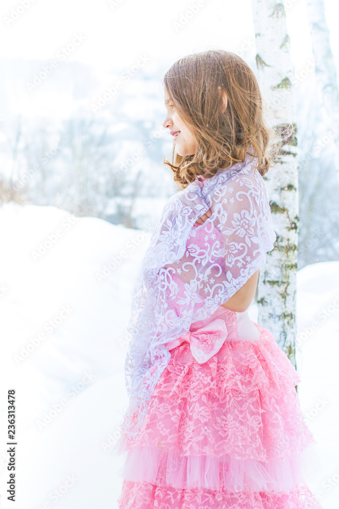 A beautiful girl walks on a frozen forest covered with snow. A beautiful girl walks on a frozen forest covered with snow.
