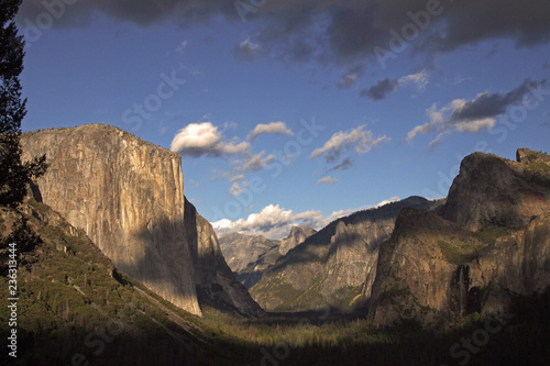 view over Yosemite Valley at early evening from Wawona Tunnel vista point with El Capitan on the left, Half Dome on axis and Bridalveil Fall on the right, California, USA photo