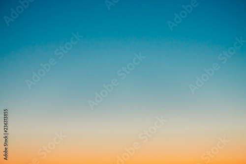 Fototapeta Predawn clear sky with orange horizon and blue atmosphere