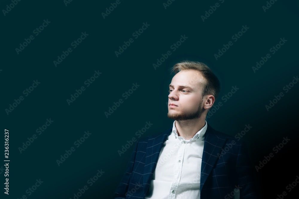 European male businessman, blond in a studio in blue. Successful, serious man European male businessman, blond in a studio in blue. Successful, serious man