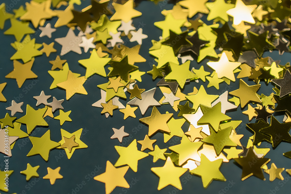 Golden confetti stars scattered on the surface. Golden confetti stars scattered on the surface.