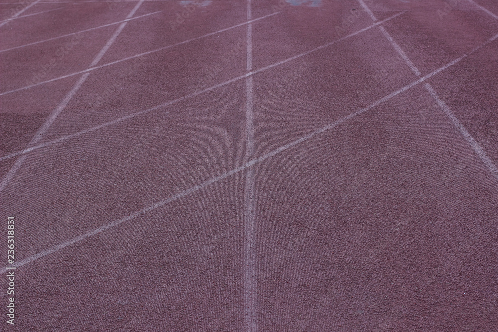 poor soft color running track on sport  stadium place background texture surface with marking and empty copy space