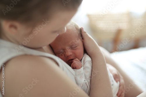 newborn sleeps sweetly in arms of elder sister