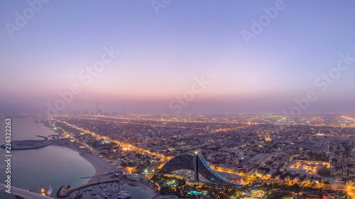 Skyline view of Dubai from night to day transition, UAE. Timelapse © neiezhmakov