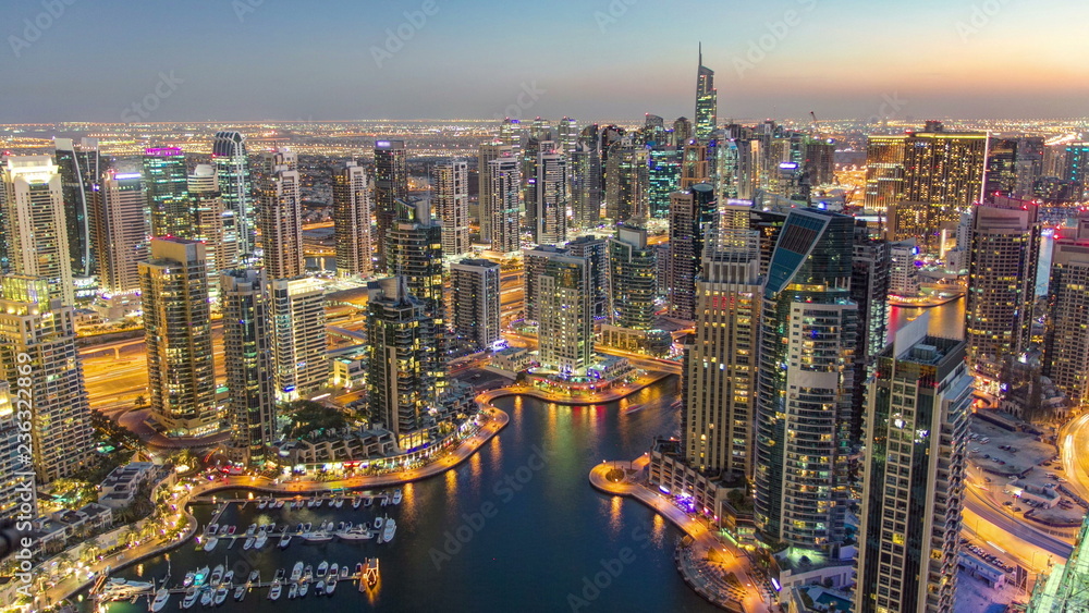 Dubai Marina with modern towers from top of skyscraper transition from day to night timelapse